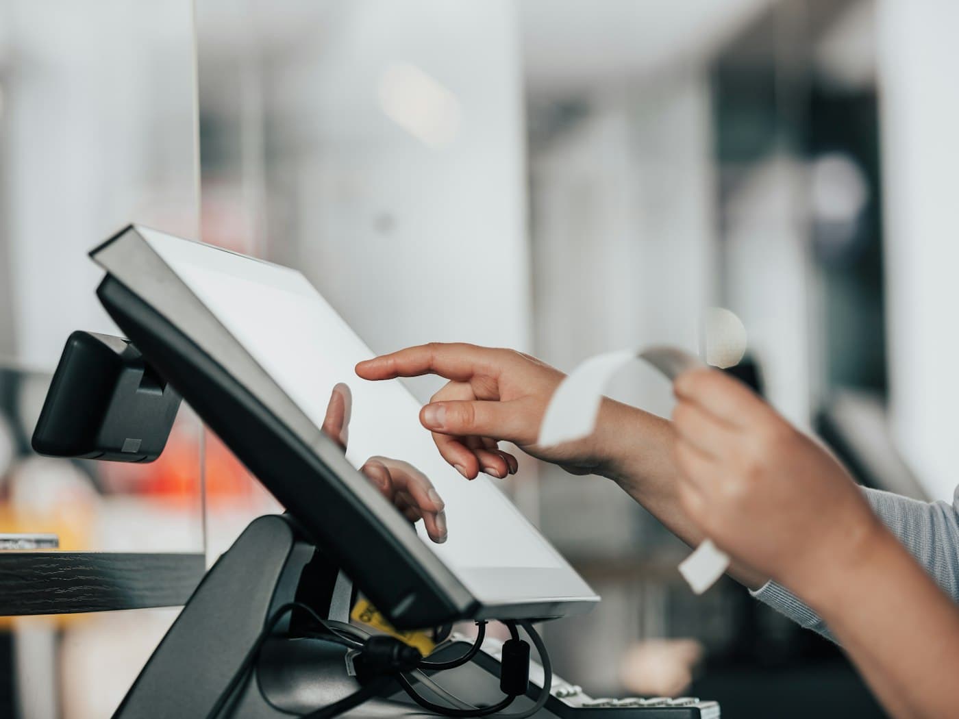 A cashier selling on finpo at a shop counter